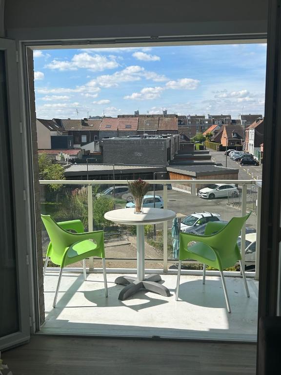 a view of a patio with a table and chairs at Wattrelos Appart'S in Wattrelos
