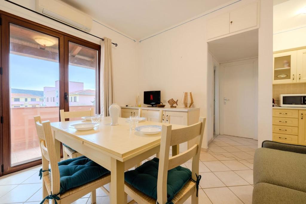 a kitchen and dining room with a table and chairs at Small paradise a few meters from the sea in Le Vecchie Saline