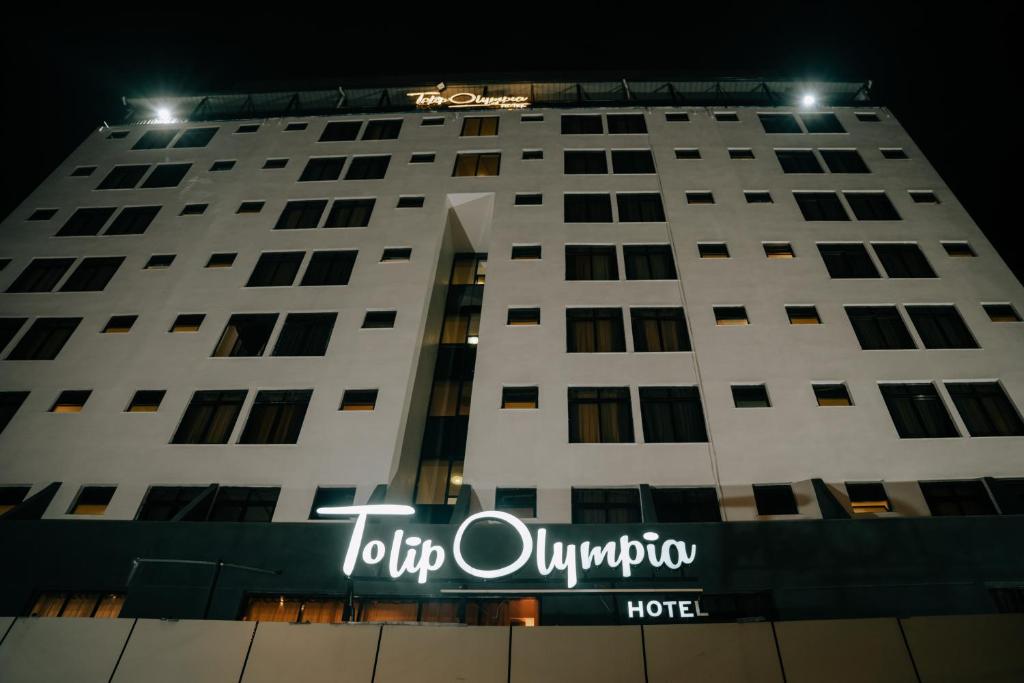 a building with a hotel sign in front of it at Tolip Olympia Hotel in Addis Ababa