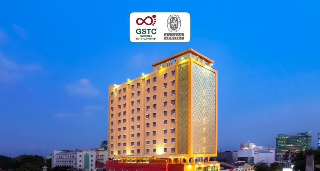 a tall building with lights on top of it at Best Western Plus Makassar Beach in Makassar