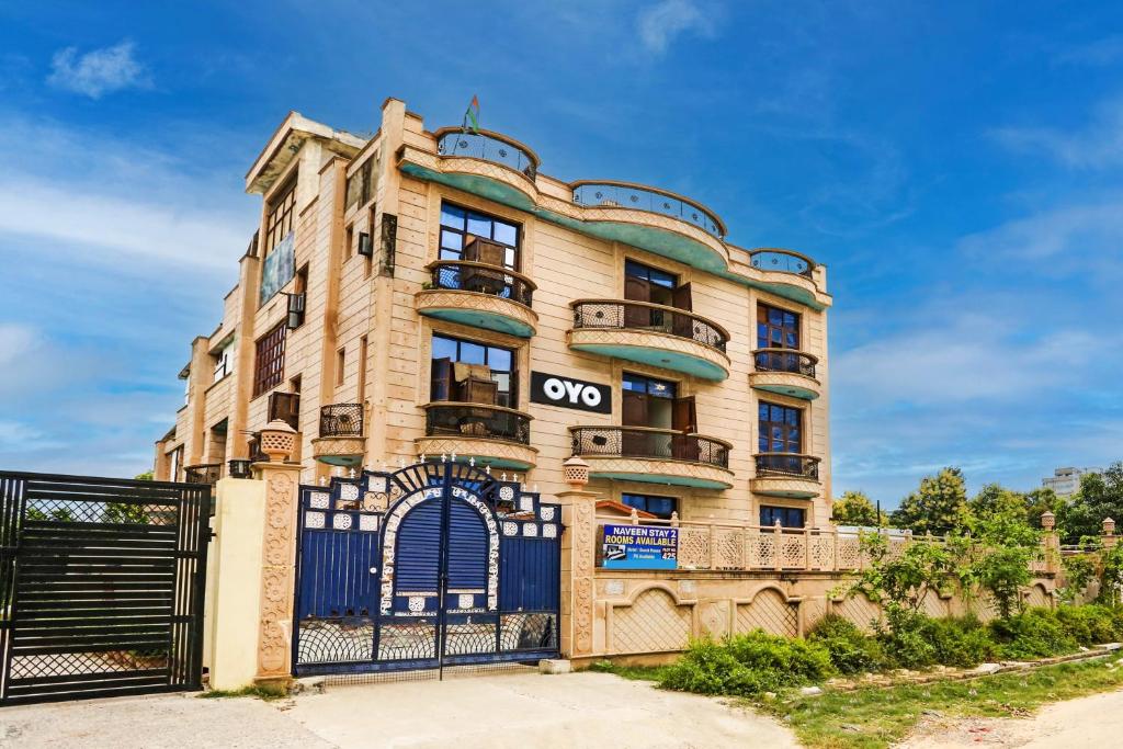 an apartment building with an open sign on it at Hotel O Naveen Stay in Manesar