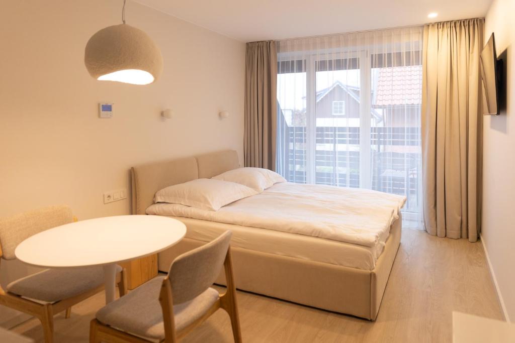 Postel nebo postele na pokoji v ubytování Wave 21 Nida Self Check-In Apartment