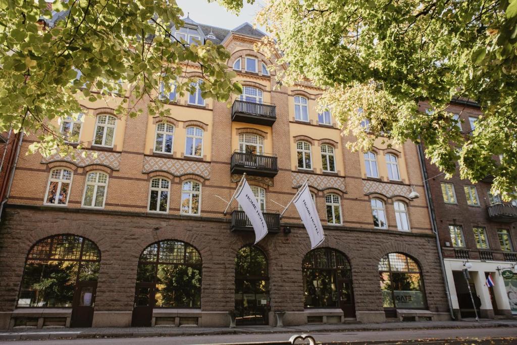 a building on the corner of a street at Home Hotel Norre Park in Halmstad