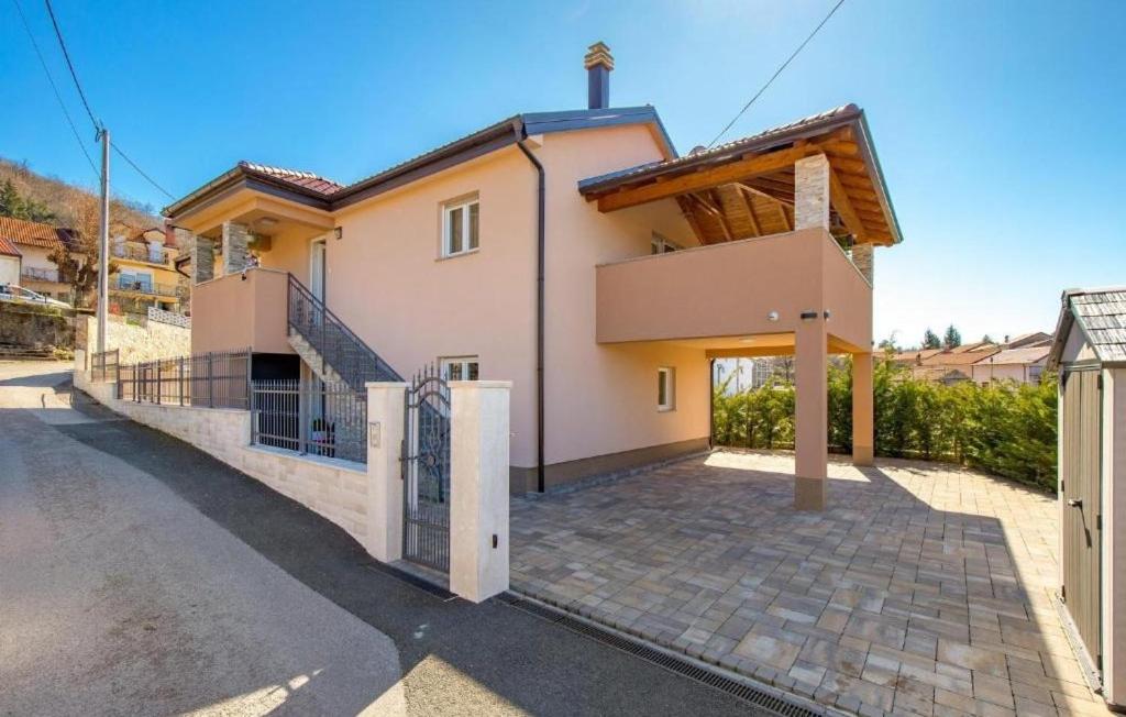 a house with a gate in front of it at Villa Lemily with private pool by Villas Guide in Lipa