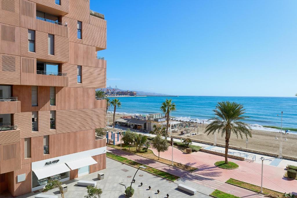 a rendering of a building next to the beach at Alma de Pacifico in Málaga