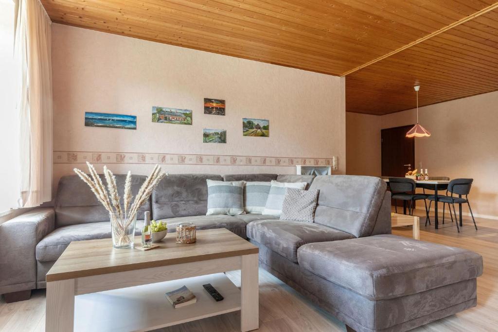 a living room with a couch and a table at Linde in Westermarkelsdorf