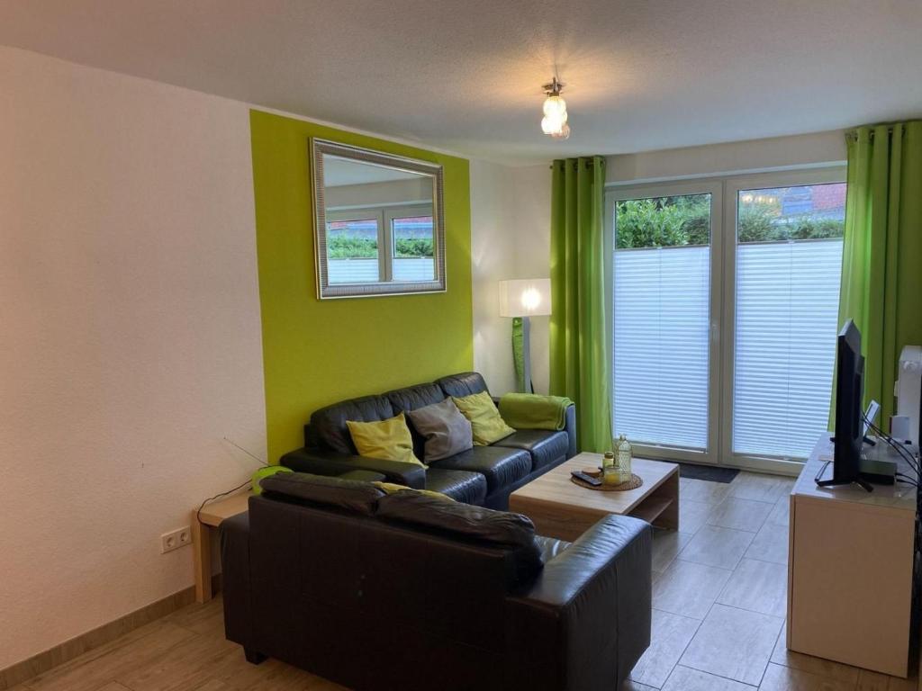 a living room with a couch and a tv at Wohnung 70 in Horumersiel