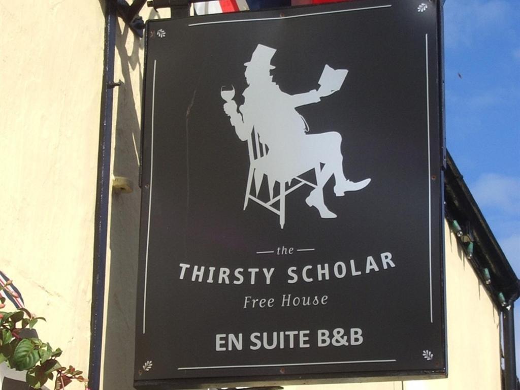 a sign for the thirsty scholar fire house em suite bbb at The Thirsty Scholar in Penryn