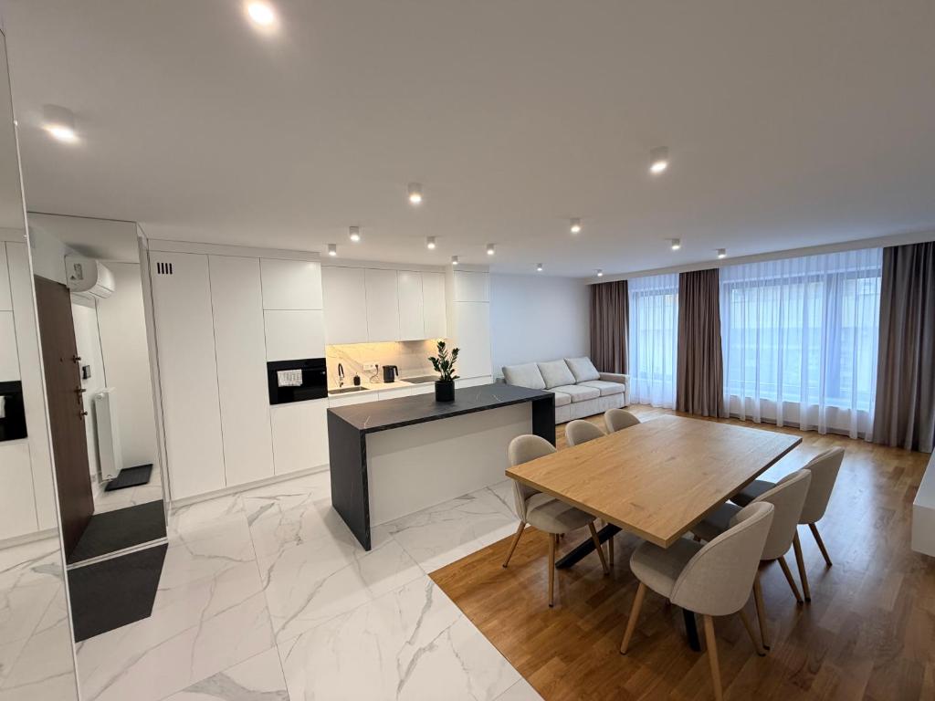 a kitchen and dining room with a table and chairs at K16 Apartments in Krakow