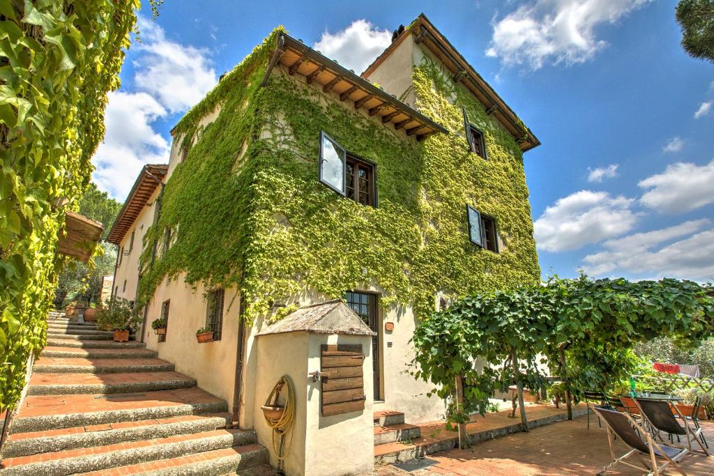 a building covered in ivy with stairs leading up to it at Tuscan Countryside near Florence in Impruneta
