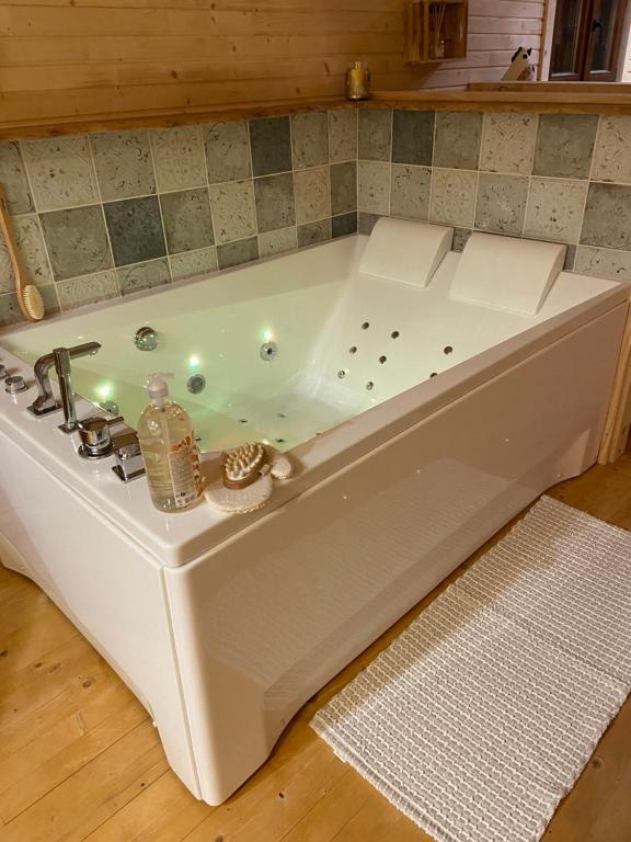 a white bath tub sitting in a room at La champ être in Neuville-sur-Sarthe