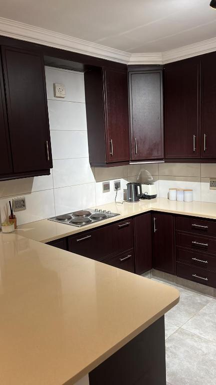 a kitchen with brown cabinets and a counter top at 8 on Lorenzo in Amanzimtoti