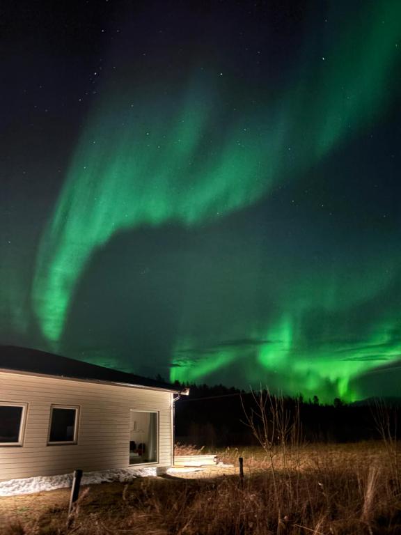 an image of the aurora borealis over a house at Apartment in Målselv in Björklid