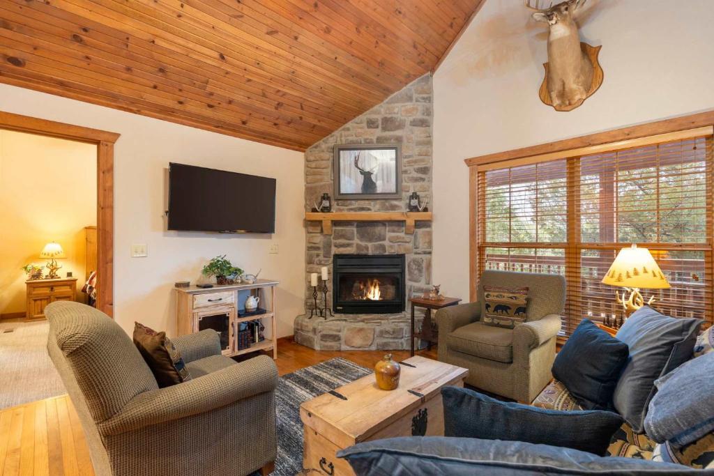 a living room with a couch and a fireplace at Simon's Treetop Cabin - 2 BDR in Popular Resort in Branson West