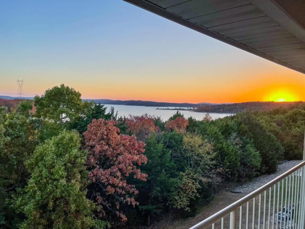 a sunset from the balcony of a house at Sunset Daydream - Elegant Condo on Table Rock in Branson