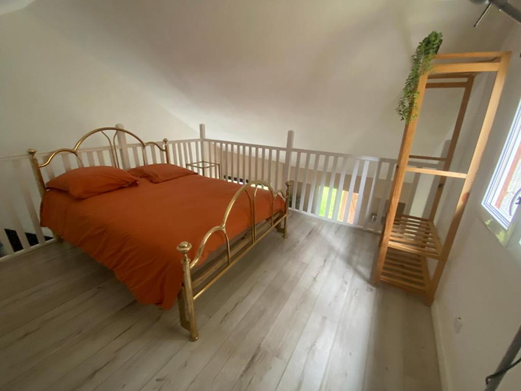 a bedroom with a bed and a ladder and a mirror at Calme et nature in Venoy