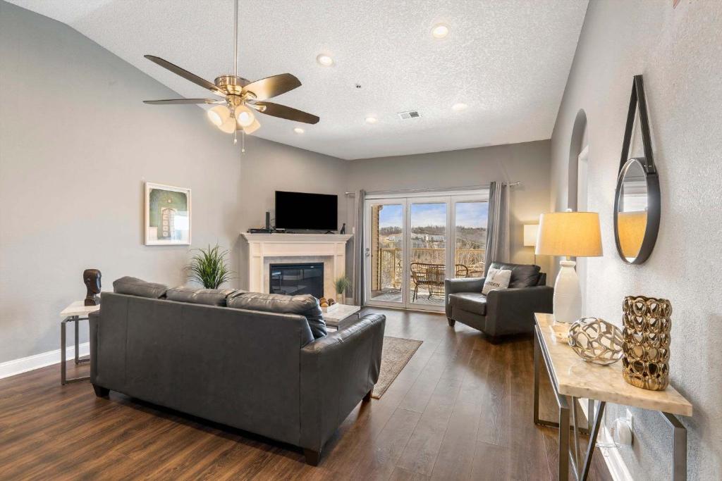 a living room with a couch and a fireplace at Great Escape Duo in Branson