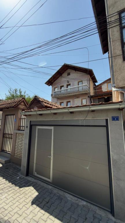 a garage door in front of a house at Holiday home Mitrovicë in Mitrovica