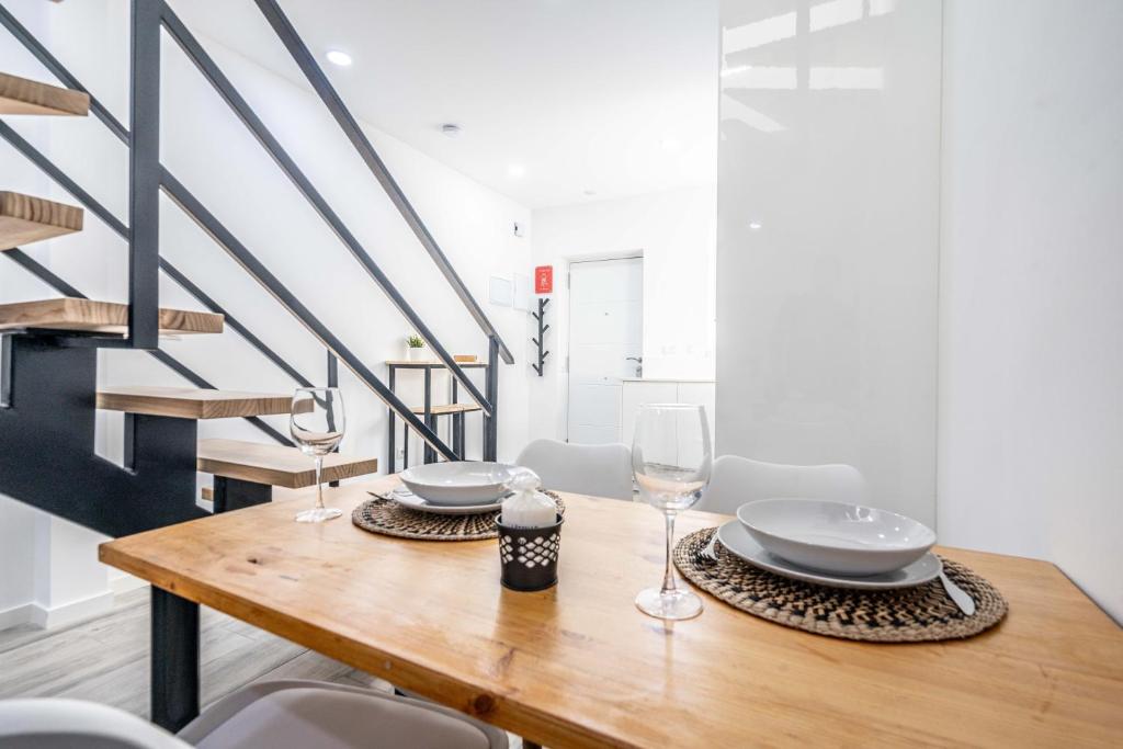a dining room table with glasses and plates on it at Duplex-Port-Valencia 14 in Valencia