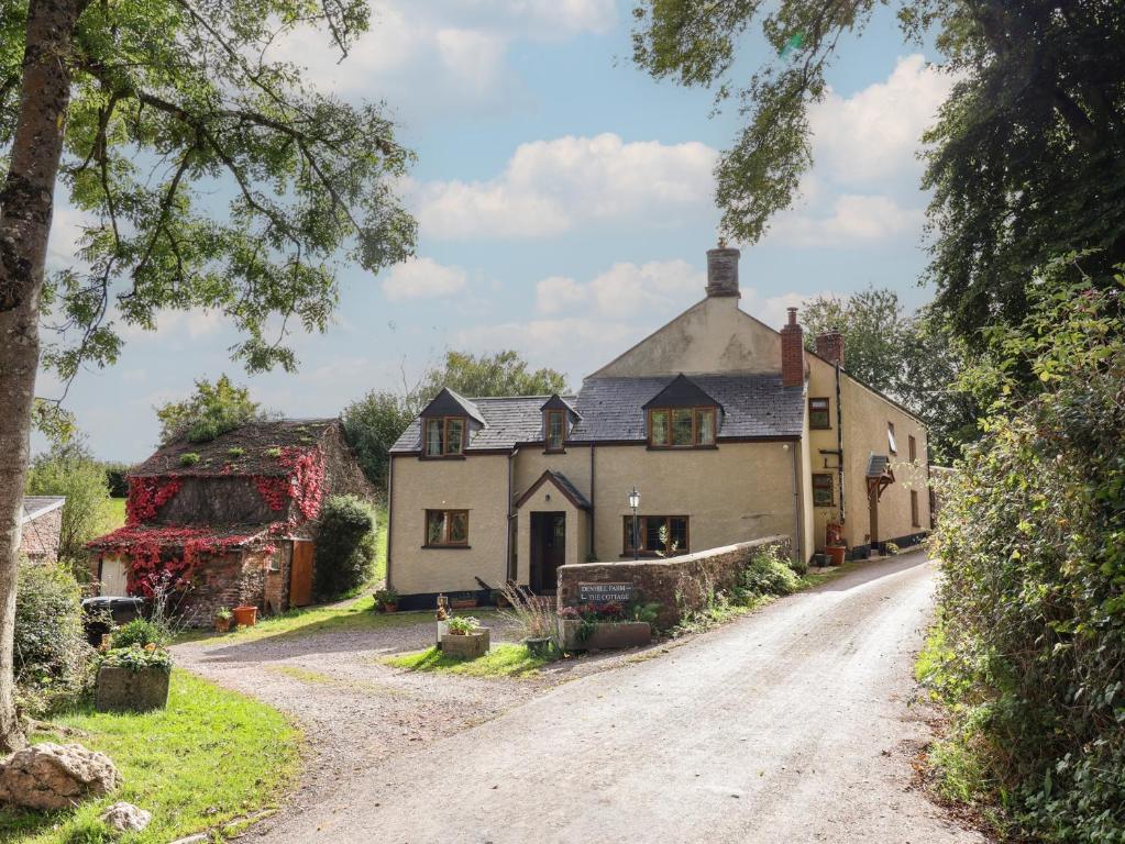 an old farm house on a dirt road at Denhill Cottage in Taunton