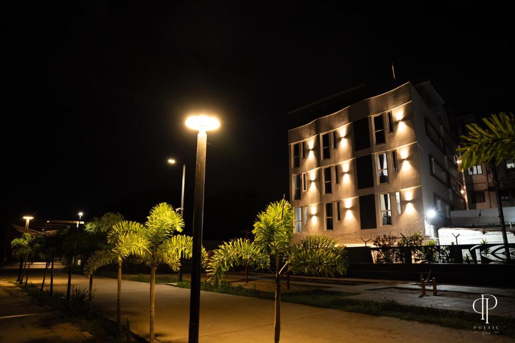 a building with a street light in front of it at night at Aafiya lakeview Apartments in Coimbatore