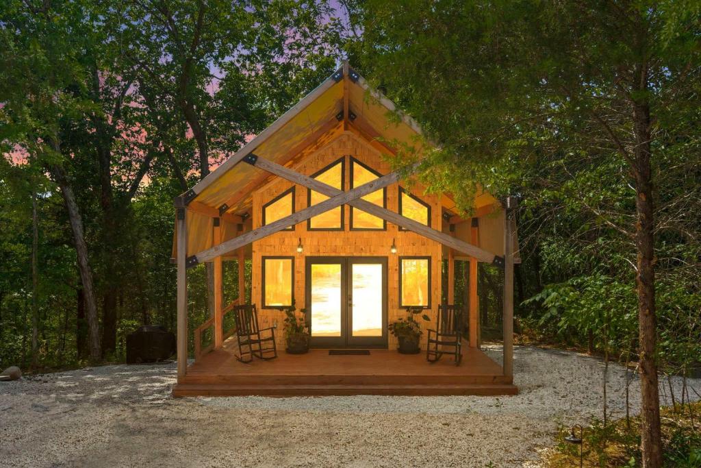 a small cabin in the middle of a forest at Cedar Creek - Glamping in the Ozarks in Walnut Shade