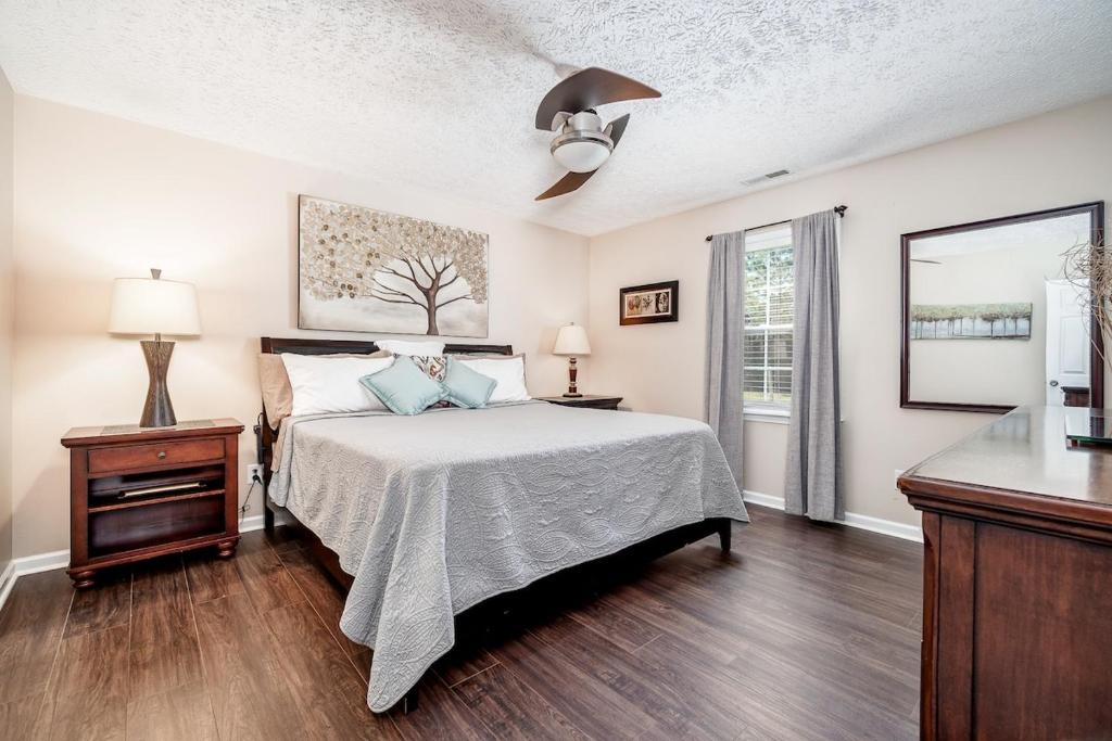 a bedroom with a bed and a ceiling fan at 3BR Home with Smart TVs in Every Room, King Suite & Pool Table in New Bern