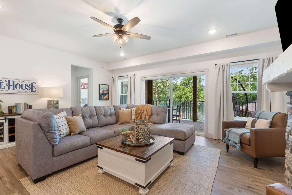 a living room with a couch and a ceiling fan at New Lakeside Haven - Picturesque in Branson