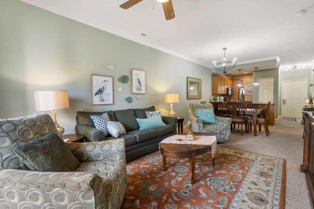 a living room with a couch and a table at Blue Heron Hideaway - Table Rock Lake in Branson