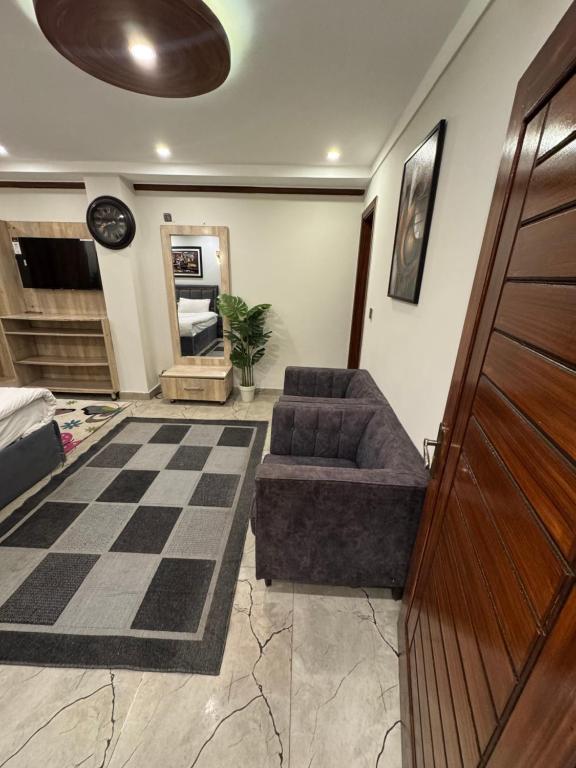 a living room with a couch and a checkered floor at Hotel SecondHome in Murree