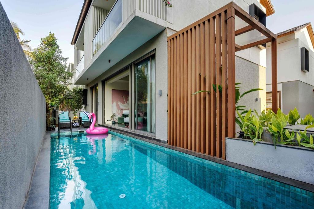 a swimming pool with a pink flamingo in a house at Villa Kosha - Lux 3BR Villa wPrivate Pool Siolim in Siolim