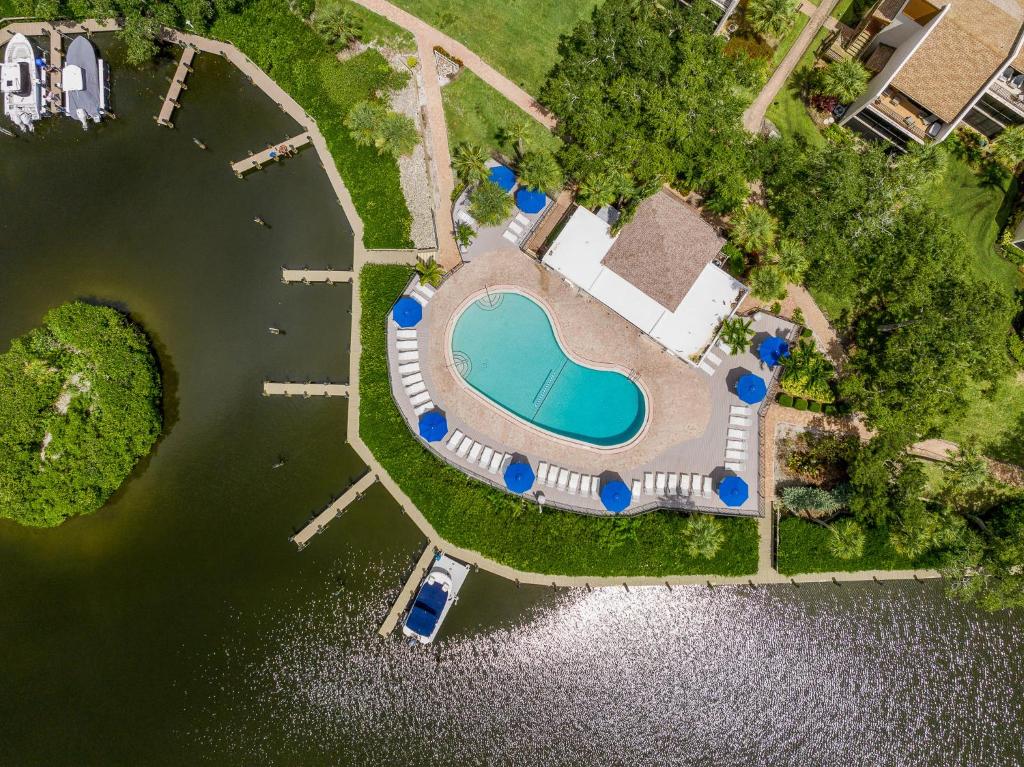 an overhead view of a swimming pool next to a body of water at Midnight Cove II 211F in Siesta Key