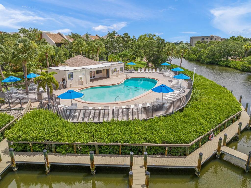 an overhead view of a swimming pool with umbrellas at Midnight Cove II 213F in Siesta Key