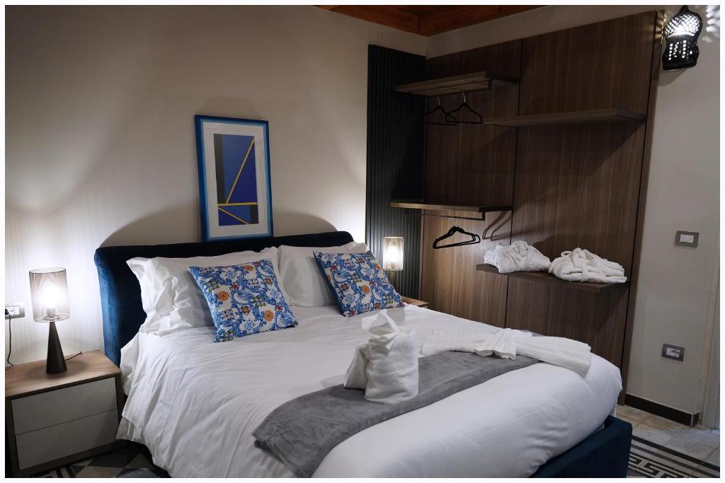 a bedroom with a large white bed with pillows at Hotel Villa Nunziante Pompei in Scafati