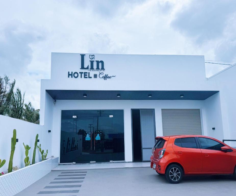a red car parked in front of a hotel at Lin Hotel and Coffee in Hòa Bình