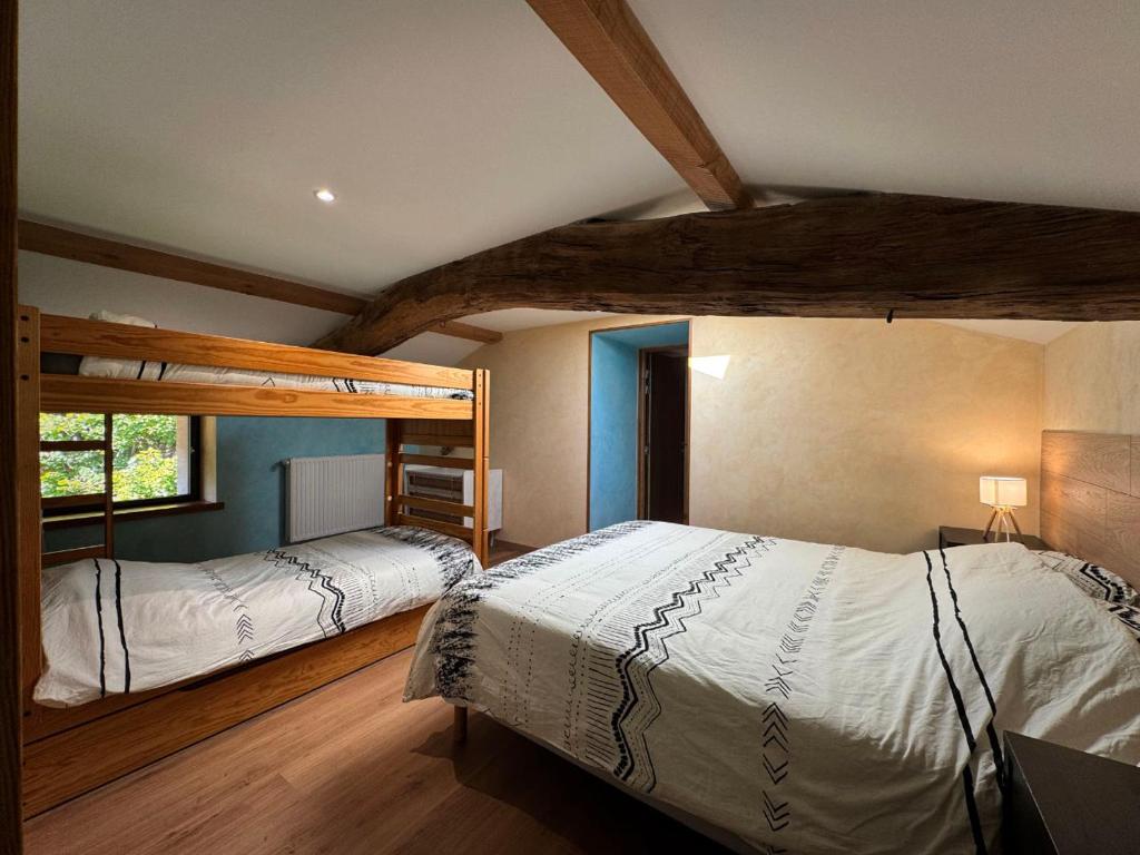 a bedroom with two bunk beds and a window at Chez Delphine in Doizieux