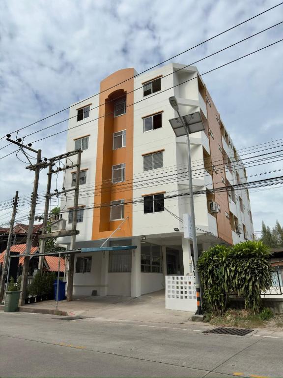 a building on the corner of a street at บ้านบี เซอร์วิส อพาร์ตเมนต์ in Si Racha