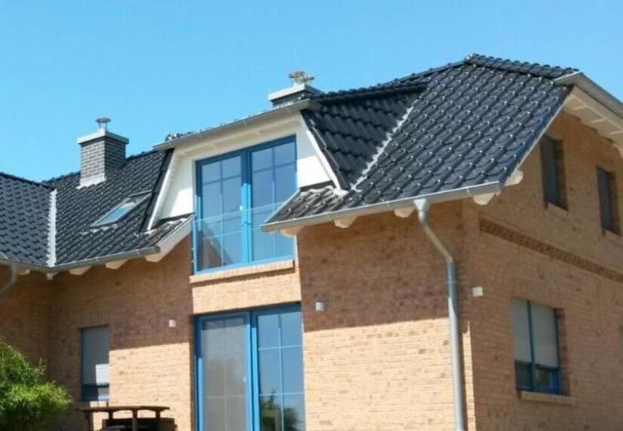 a building with a black roof on top of it at Möwe in Lancken-Granitz