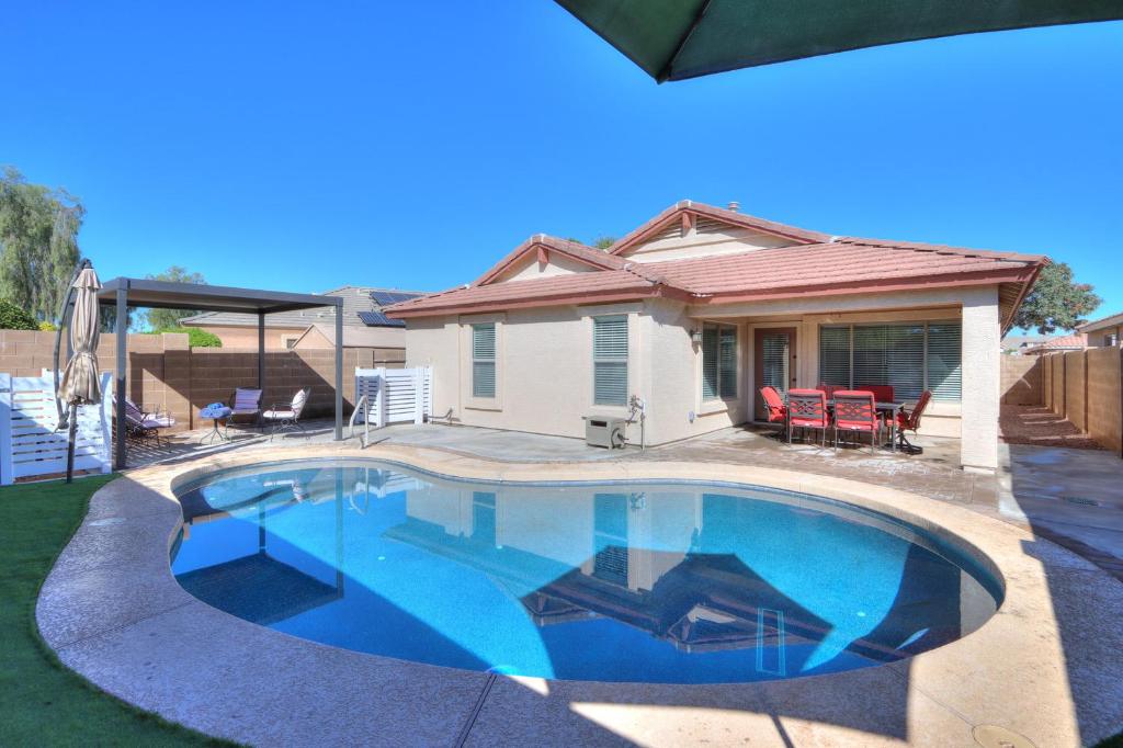 a swimming pool in front of a house at Private Mini Serene Oasis with Pool in Maricopa