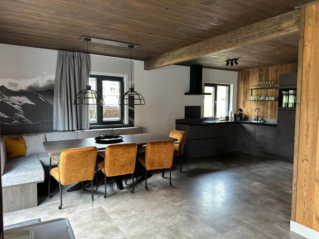 a kitchen and dining room with a table and chairs at Chalet am See! in Afritz