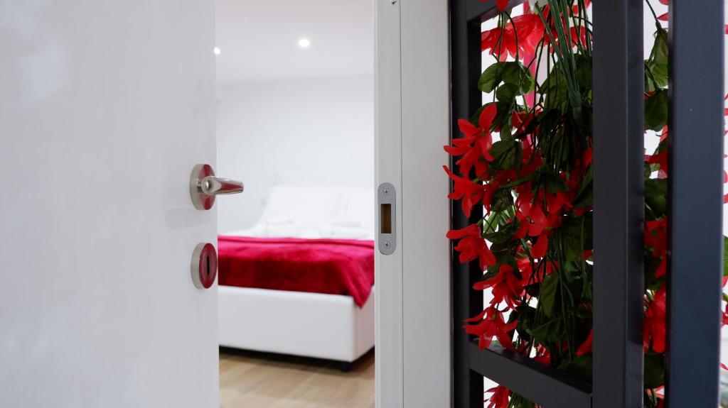 a door with red flowers in a room at Luxury Royal House in Palermo