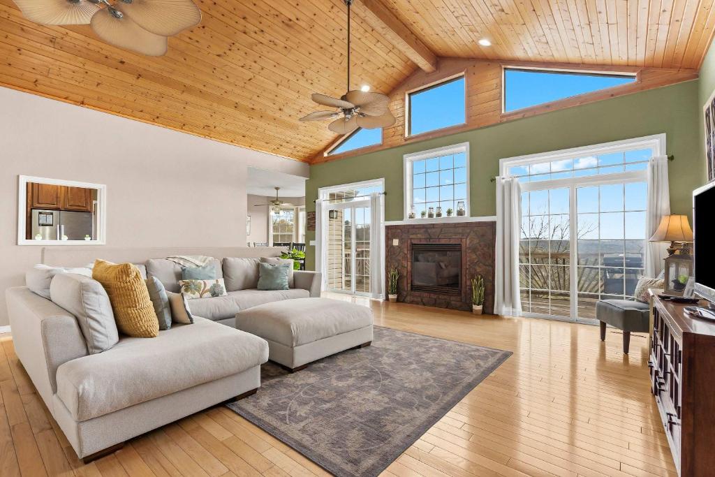 a living room with a couch and a fireplace at The Greenview Manor with Lake Views in Kimberling City
