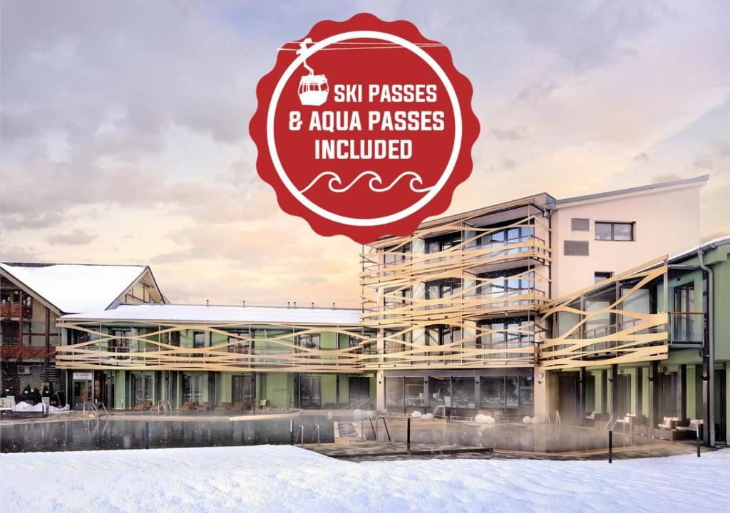 a building with a sign that reads six passes and aquarius passes included at Hotel Galeria Thermal Bešeňová in Bešeňová