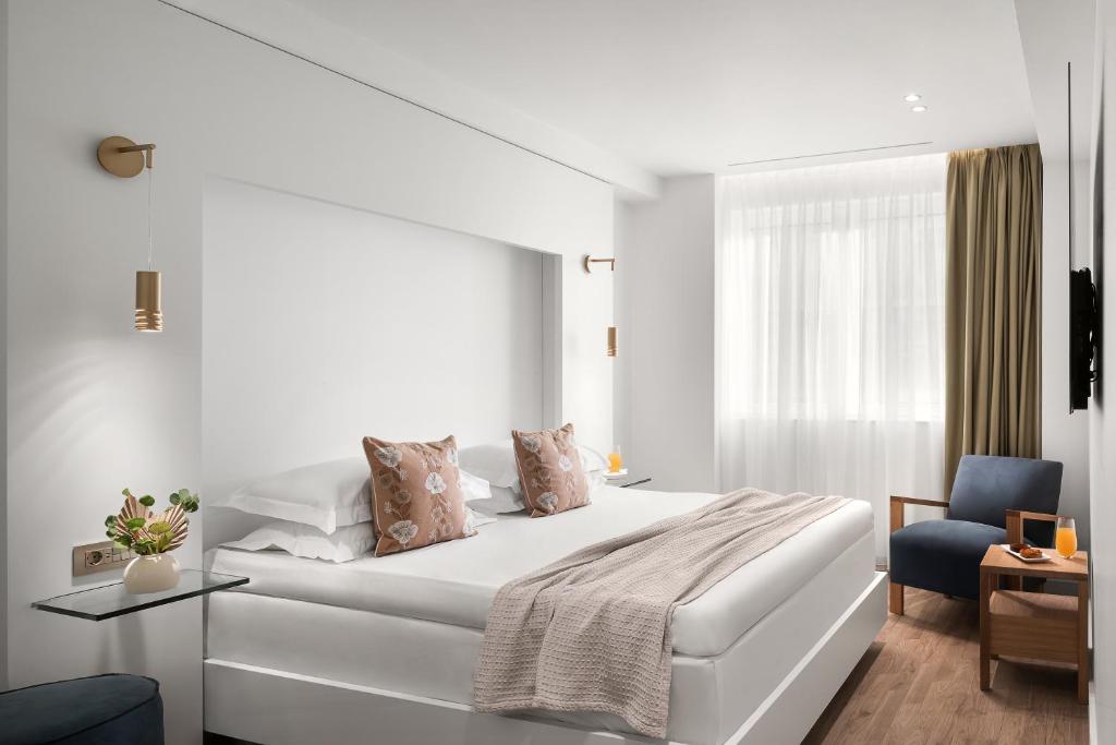 Ένα ή περισσότερα κρεβάτια σε δωμάτιο στο White Rose Athens Residence