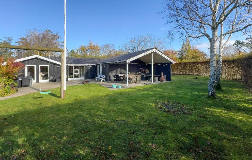 a house with a large backyard with a yard at Stunning Home In Tarm With Sauna in Højsand