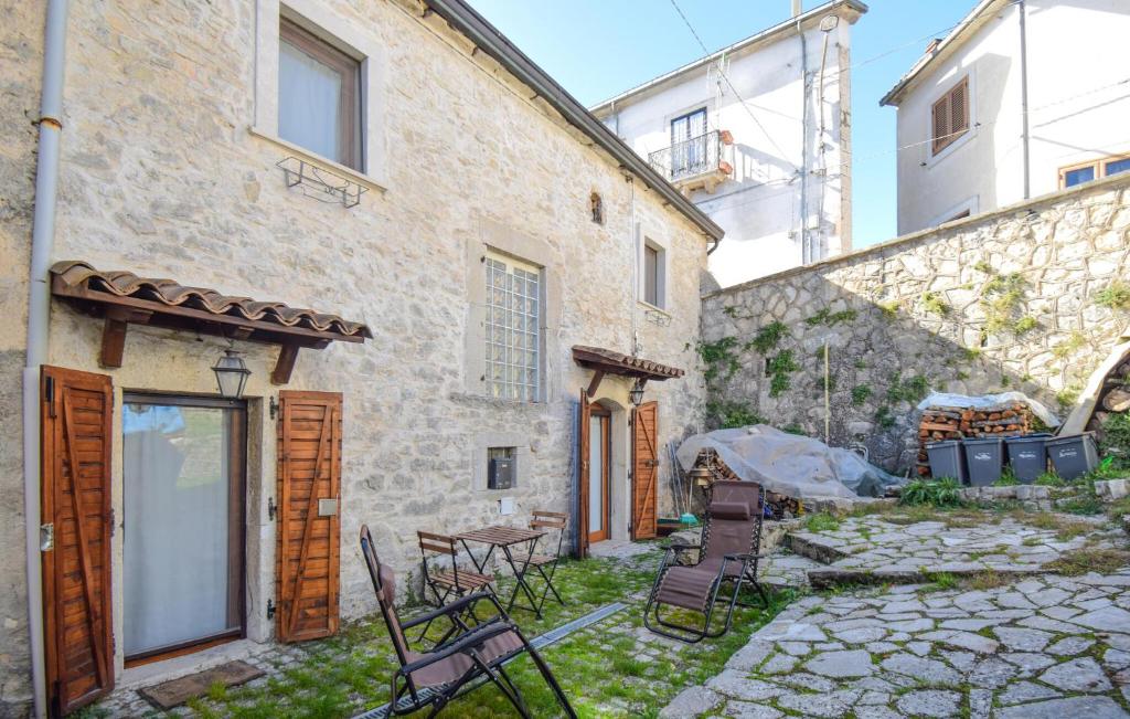 a stone building with a table and chairs in a yard at 4 Bedroom Stunning Home In Montenero Val Cocchiar in Montenero Val Cocchiara
