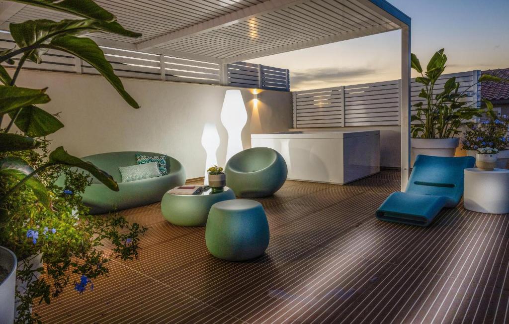 ein Wohnzimmer mit blauen Möbeln und Pflanzen in der Unterkunft Cozy Apartment In Marina Di Ragusa With Wifi in Marina di Ragusa