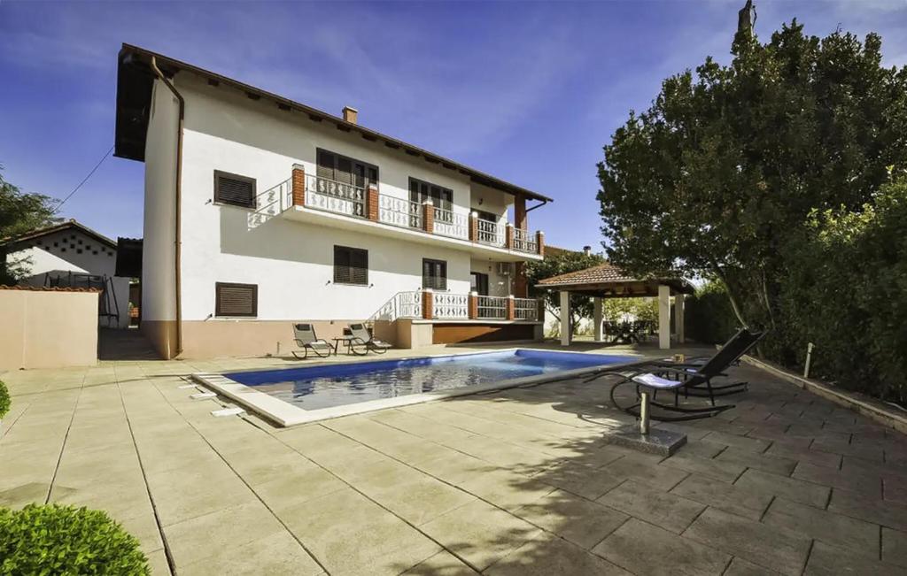 a house with a swimming pool in front of it at Amazing Home In Polaca in Pertenjača