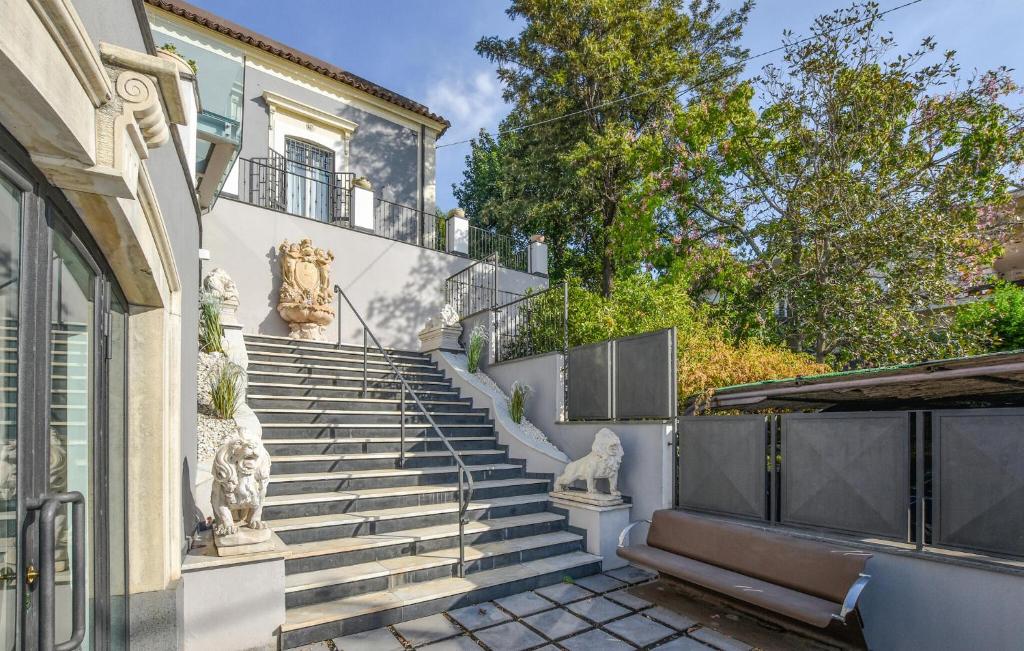 a set of stairs in front of a building with statues at Le Stanze Letterarie in Cibali