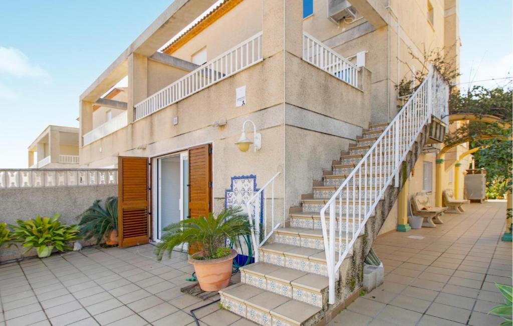 a building with stairs on the side of it at Beautiful Apartment In Oliva With Wifi in Playa Oliva Nova